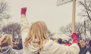 People at a protest with a sign