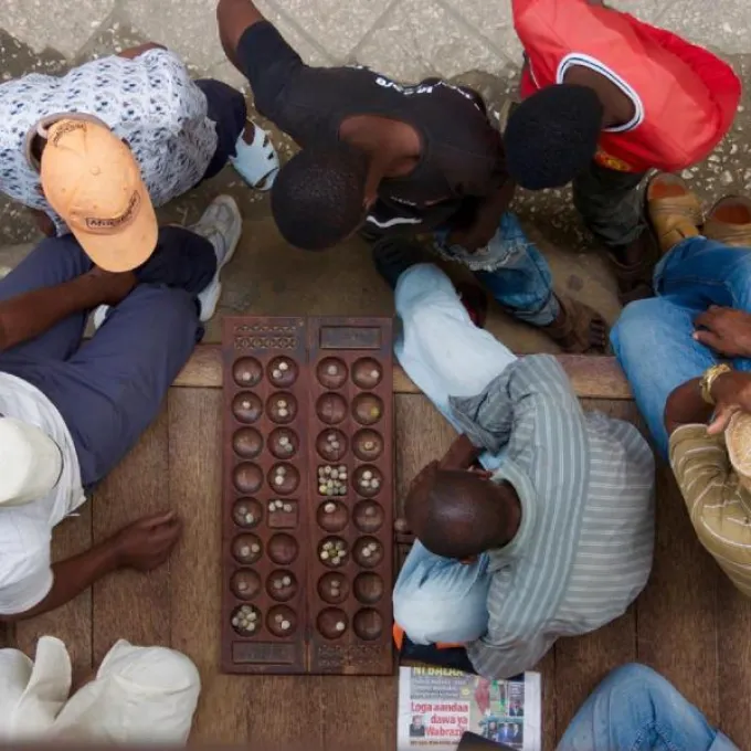 Men playing a wooden board game. 