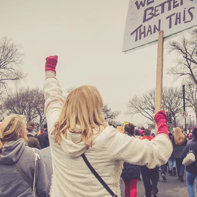 People at a protest with a sign